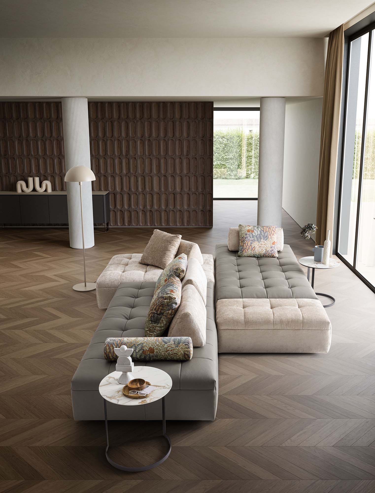 Isole di relax composte da moduli di divano affiancati e schienali traslabili e mobili. Colori bianco e grigio.